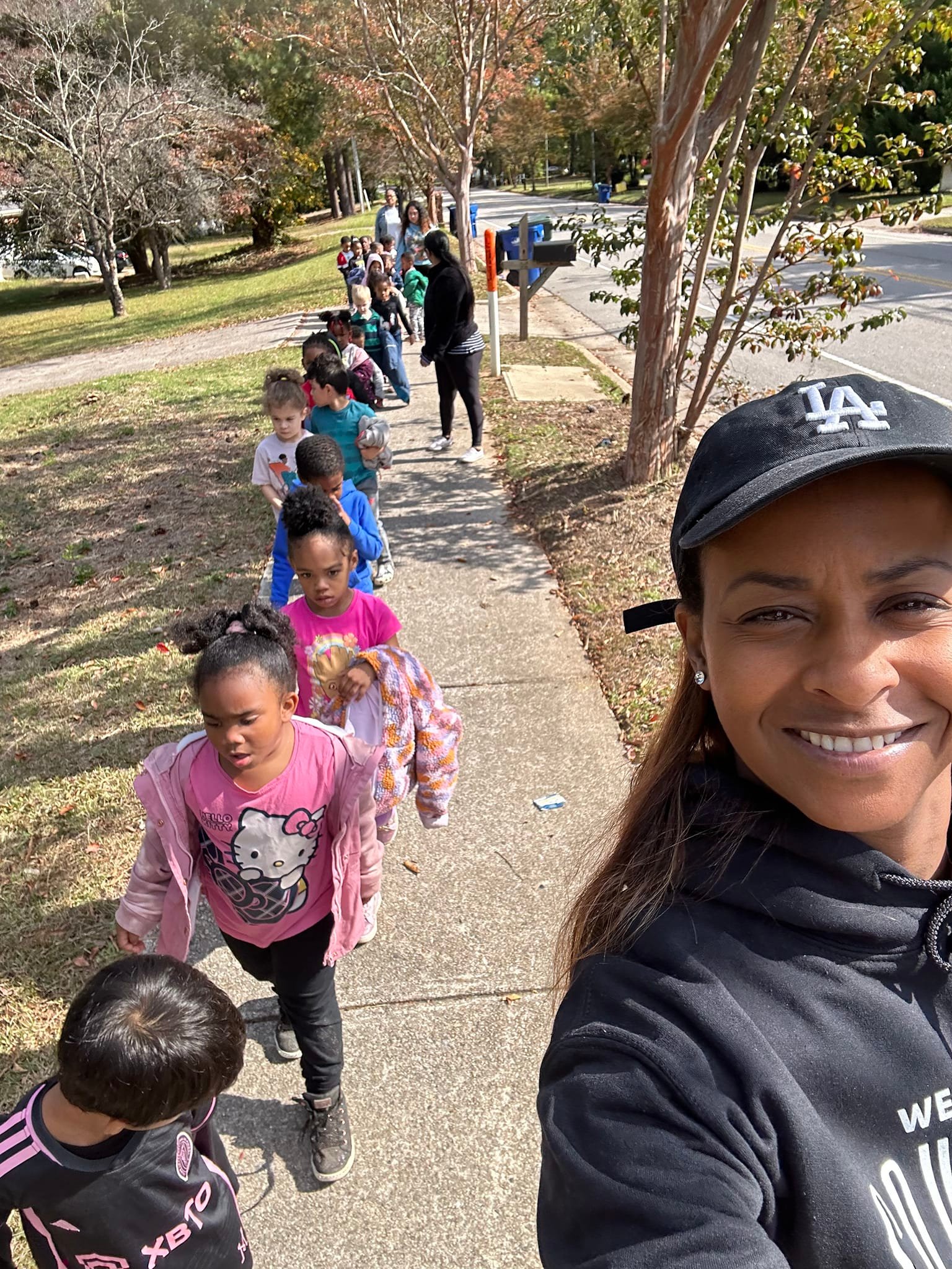 preschool class walk on the sidewalk with teachers